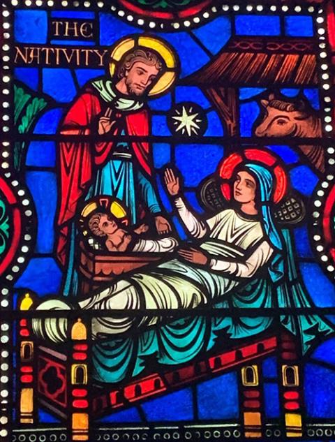 A stained-glass window at St. Augustine Catholic Church in Montpelier, Vermont, depicts the Nativity scene with an ox in the stable. (Damian Costello)